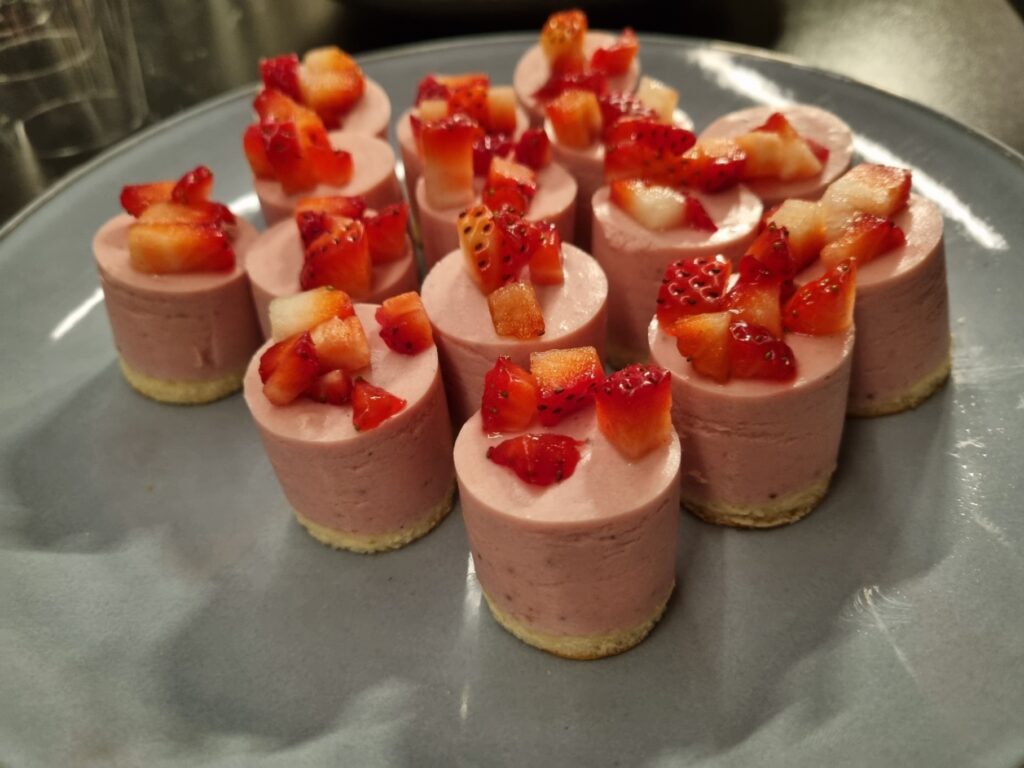 Brunch met roze mousse-taartjes en aardbeien